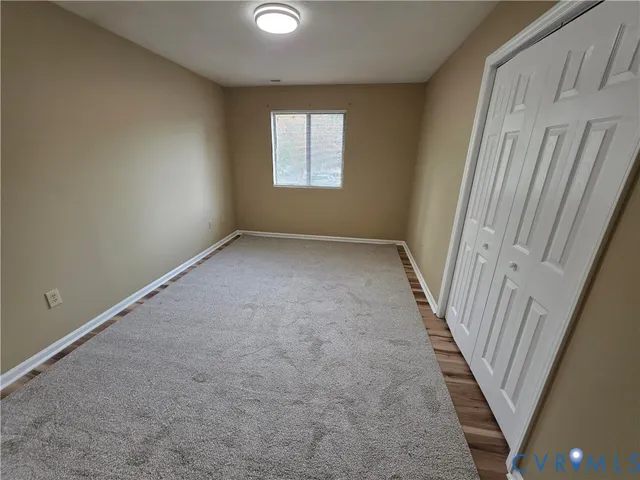 a view of hallway with stairs and a window