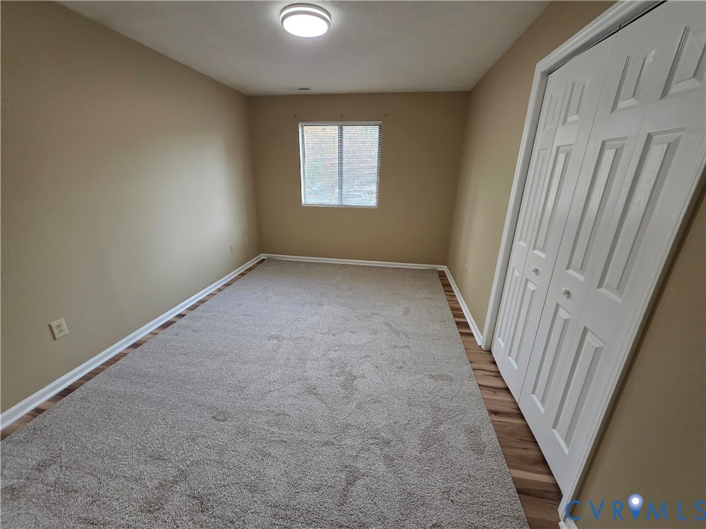 4003 Governors Square, Unit 8 Williamsburg, VA 23188 - Photo 23 of 27 an empty room with windows
