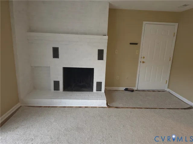 an empty room with a fireplace