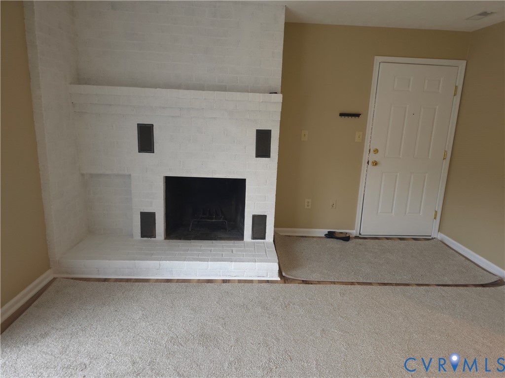 4003 Governors Square, Unit 8 Williamsburg, VA 23188 - Photo 3 of 27 an empty room with a fireplace