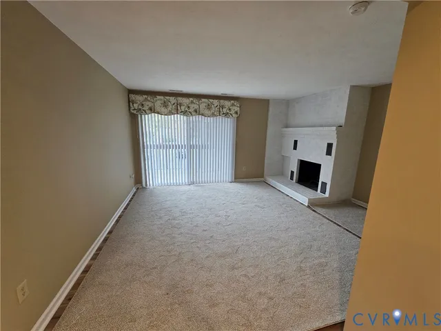a view of empty room with a fireplace