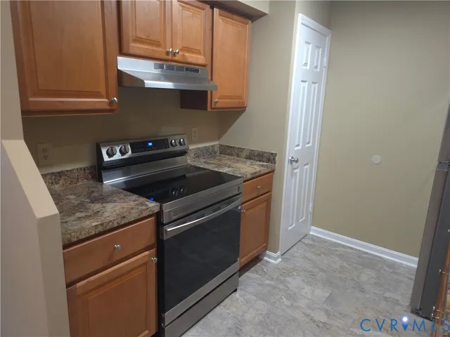 a kitchen with granite countertop cabinets stainless steel appliances and a sink