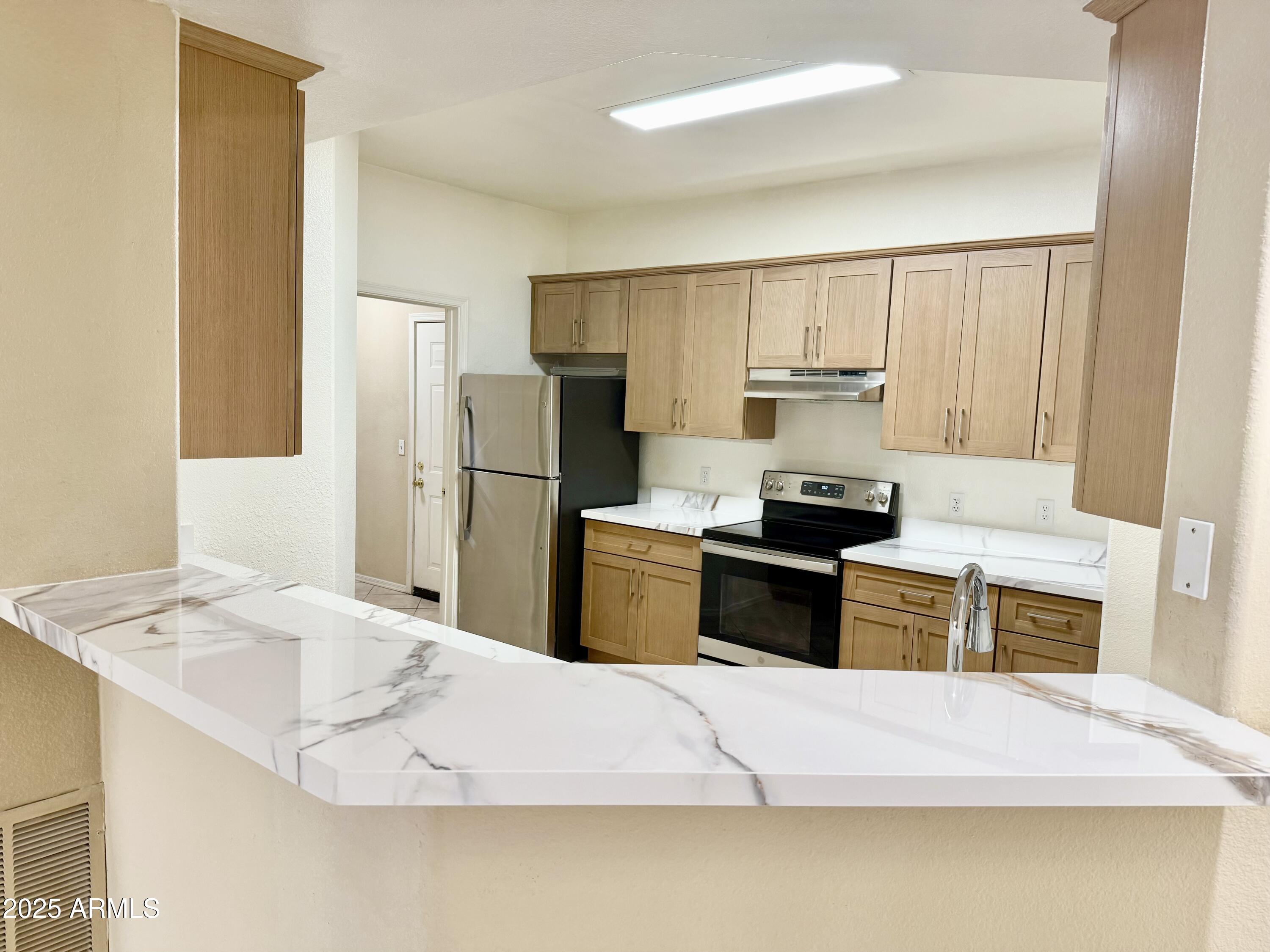 3236 East Chandler Boulevard, Unit 1071 Phoenix, AZ 85048 - Photo 12 of 35 a kitchen with a refrigerator sink and stove