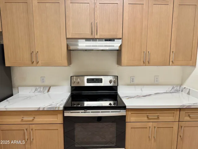 a stove top oven sitting inside of a kitchen