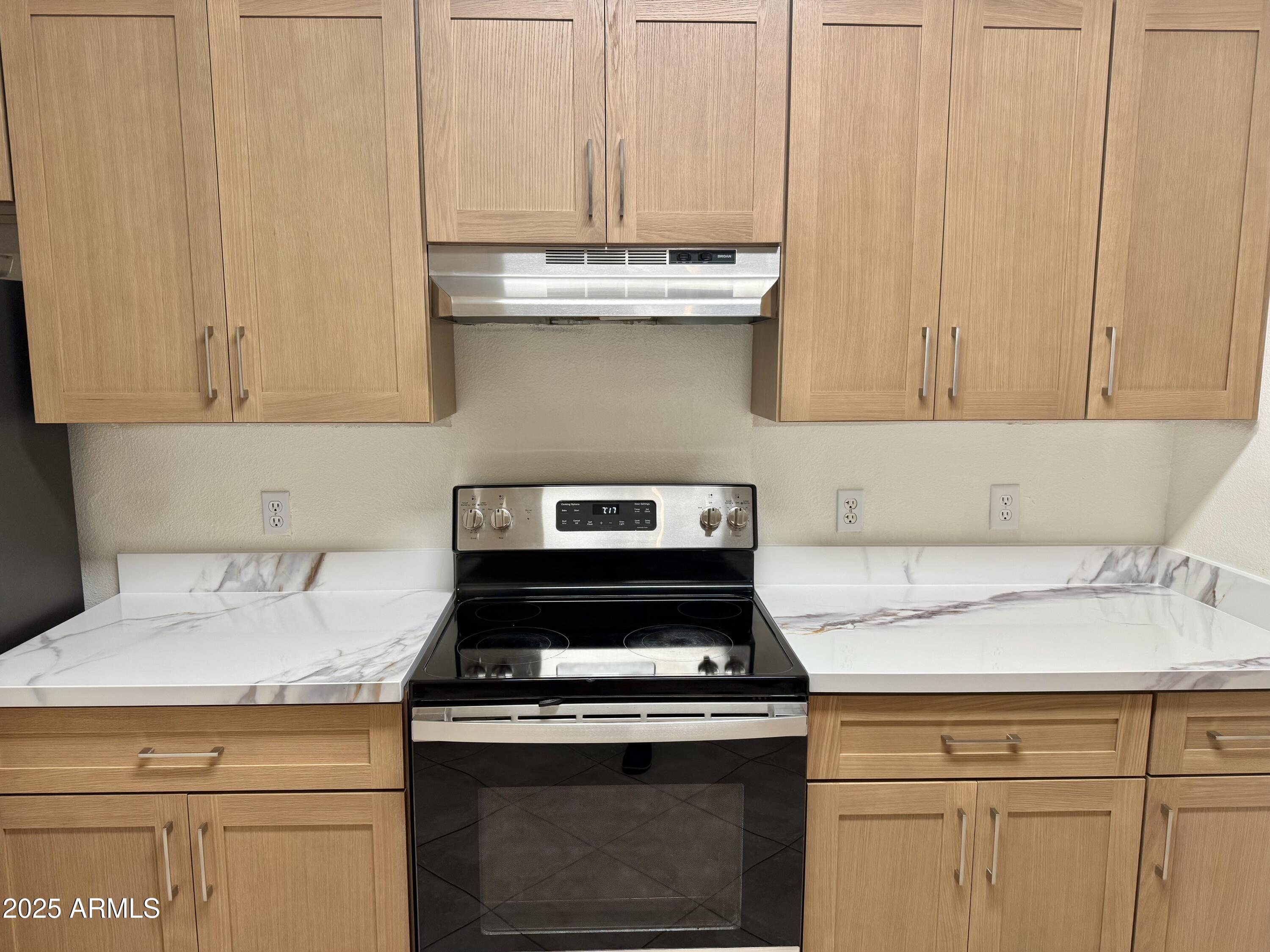 3236 East Chandler Boulevard, Unit 1071 Phoenix, AZ 85048 - Photo 15 of 35 a stove top oven sitting inside of a kitchen