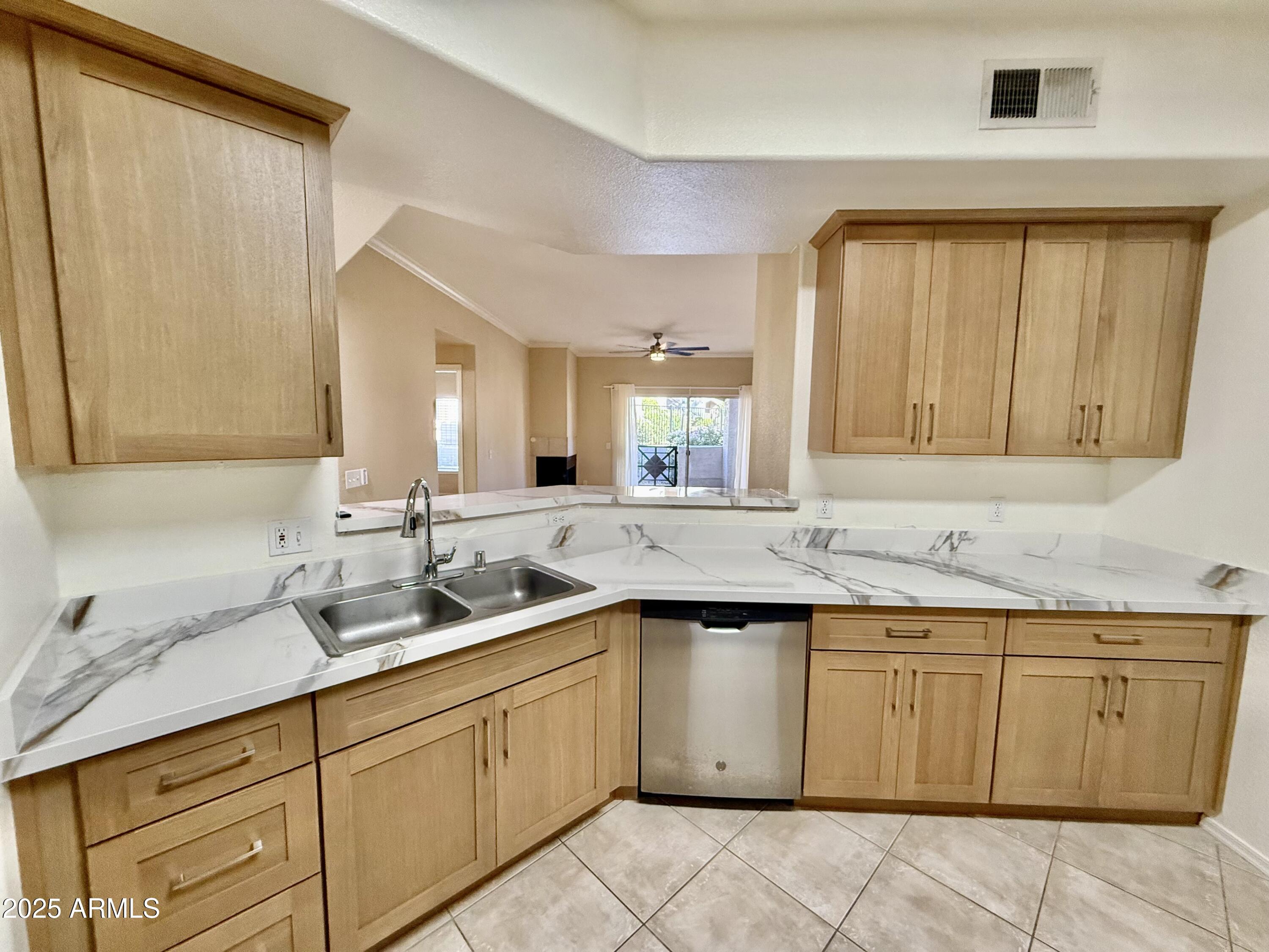 3236 East Chandler Boulevard, Unit 1071 Phoenix, AZ 85048 - Photo 18 of 35 a kitchen with a sink and cabinets