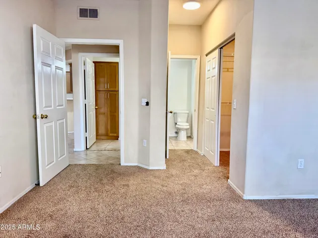 a view of a hallway with wooden shelves