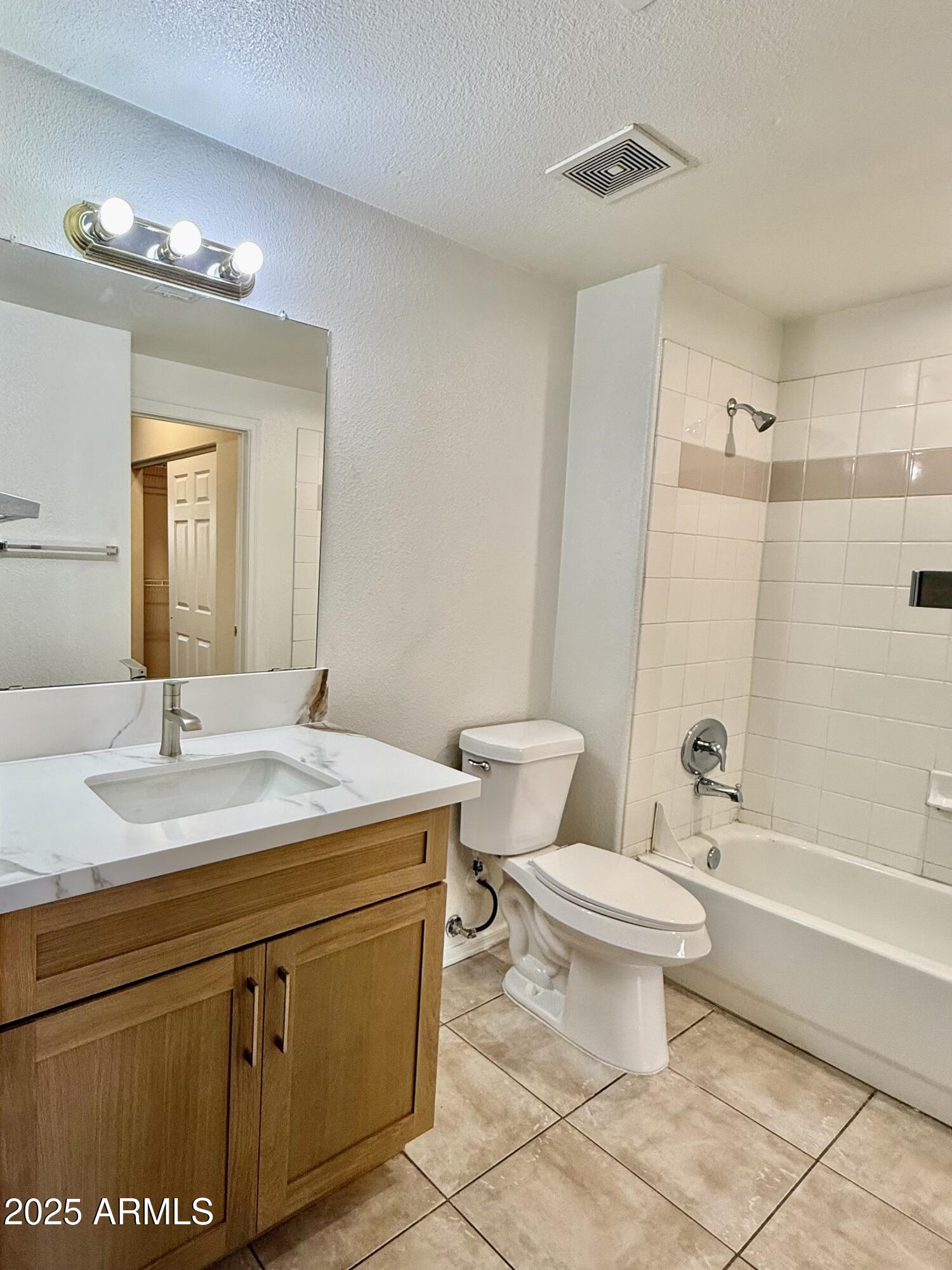 3236 East Chandler Boulevard, Unit 1071 Phoenix, AZ 85048 - Photo 30 of 35 a bathroom with a sink toilet vanity and tub
