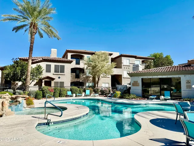 a view of a house with swimming pool and chairs