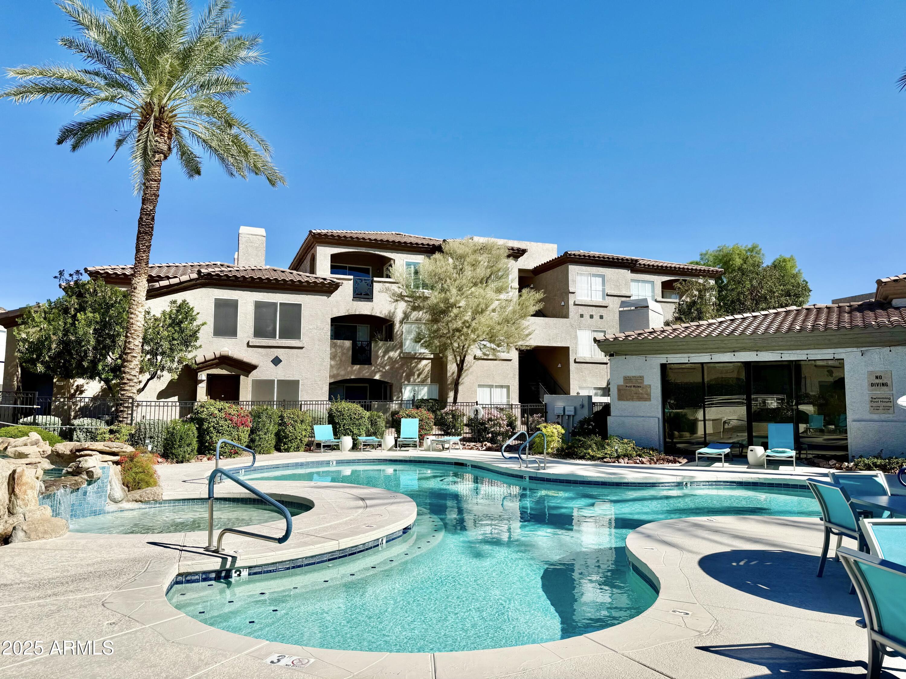 3236 East Chandler Boulevard, Unit 1071 Phoenix, AZ 85048 - Photo 3 of 35 a view of a house with swimming pool and chairs