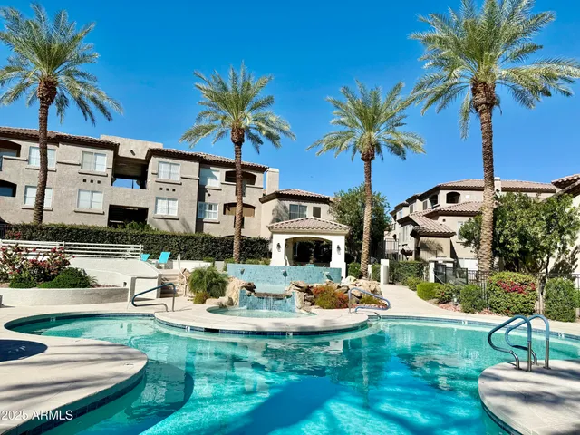 a view of a swimming pool with a table and chairs