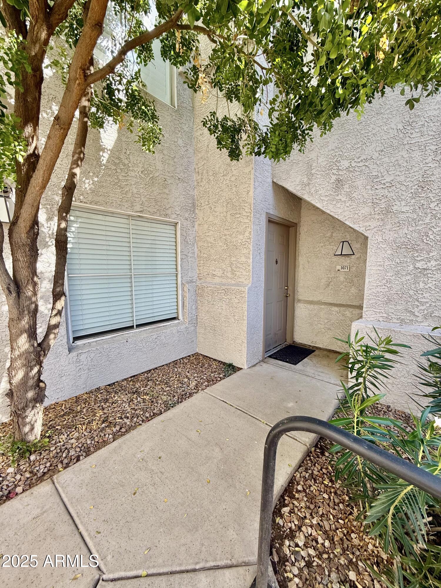 3236 East Chandler Boulevard, Unit 1071 Phoenix, AZ 85048 - Photo 6 of 35 a front view of a house with a yard