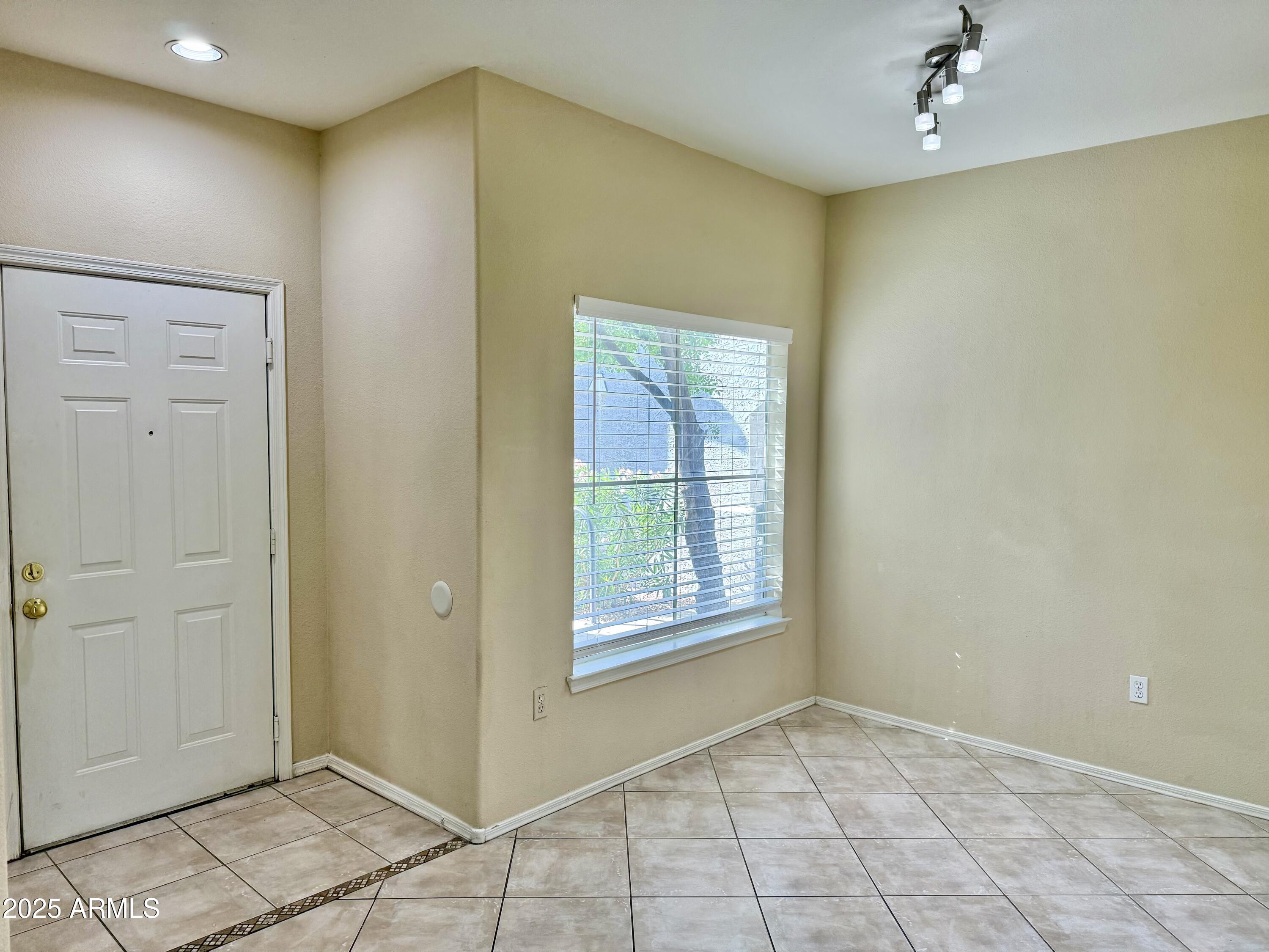 3236 East Chandler Boulevard, Unit 1071 Phoenix, AZ 85048 - Photo 7 of 35 an empty room with windows