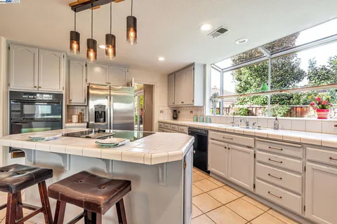 a kitchen with sink cabinets and window