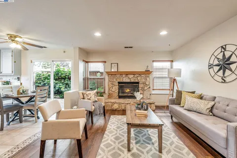 a living room with furniture a large window and a fireplace