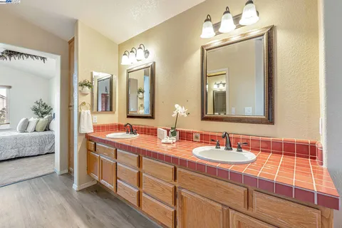 a spacious bathroom with double vanity sinks and a mirror