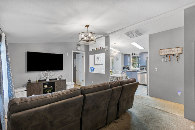 271 Mindella Way Layton, UT 84041 - Photo 6 of 27 Open-concept living area featuring a contemporary chandelier, recessed lighting, and light grey wall finishes