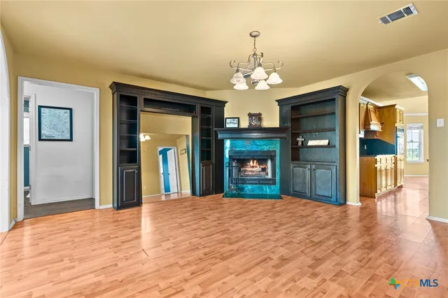 a view of a hallway with wooden floor and stairs
