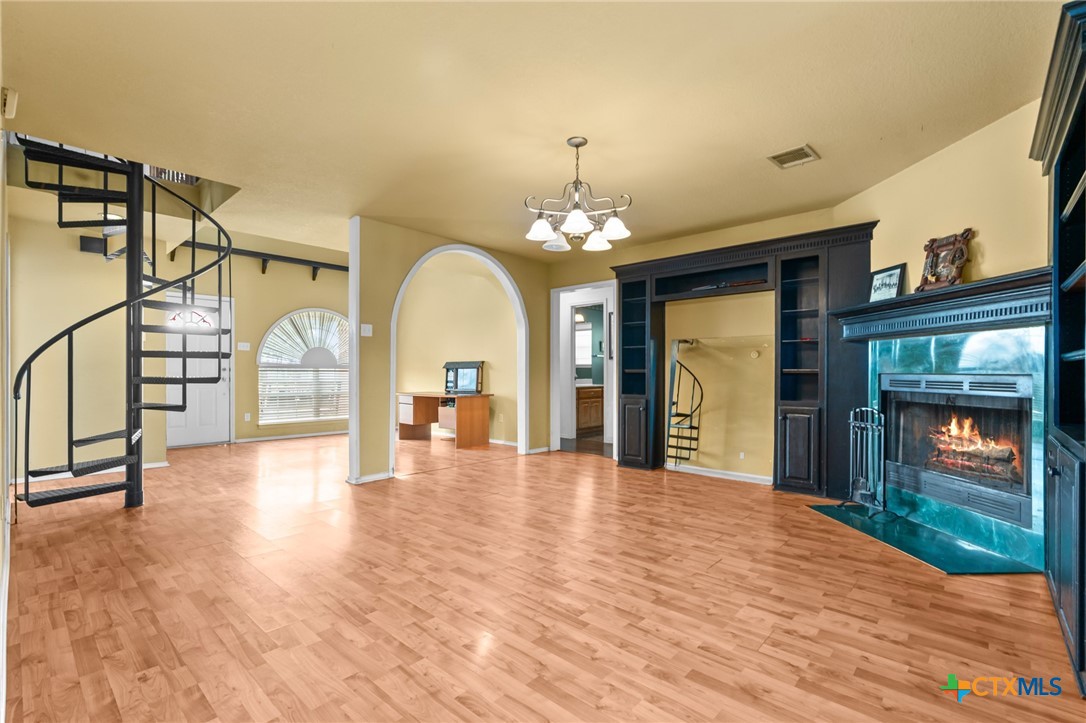411 Wade Road Eddy, TX 76524 - Photo 19 of 48 a view of a hallway with wooden floor and stairs