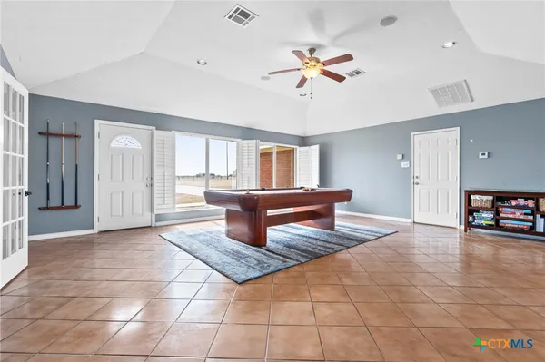 a dining room with wooden floor and a floor to ceiling window