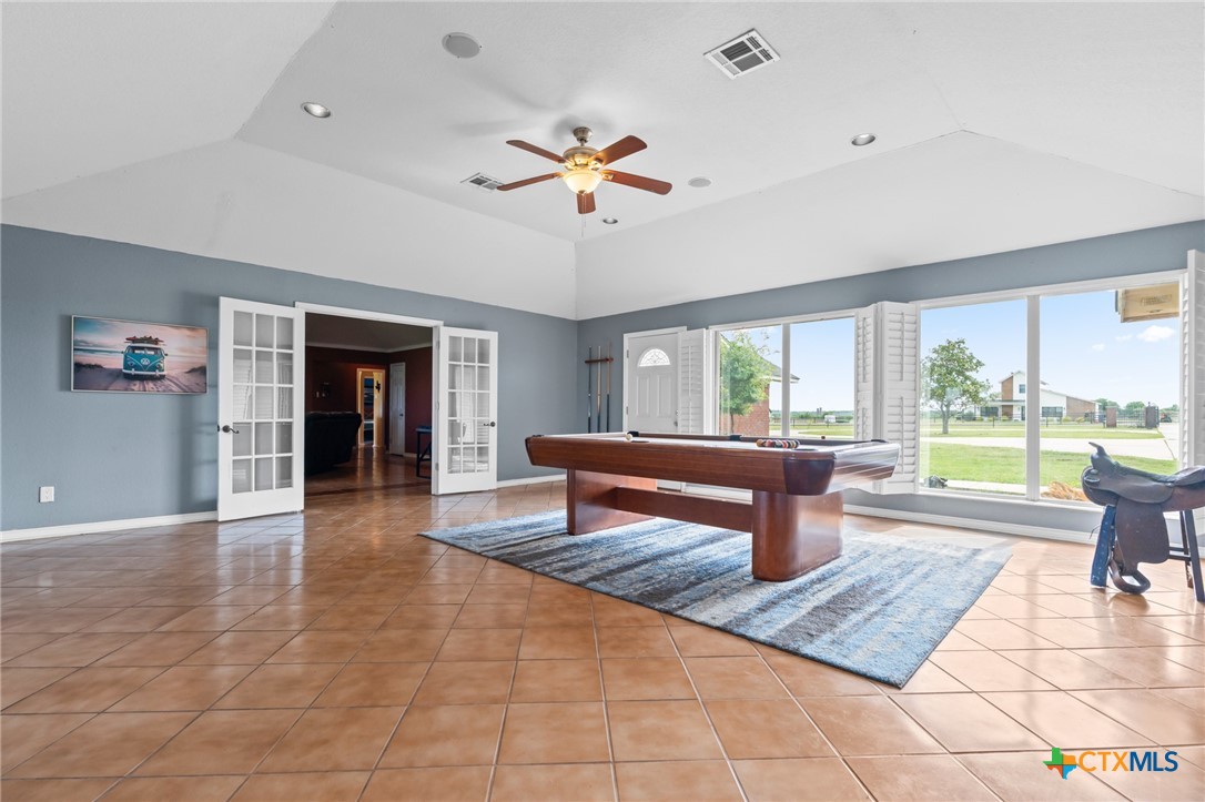 411 Wade Road Eddy, TX 76524 - Photo 22 of 48 a dining room with wooden floor and a floor to ceiling window