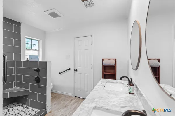 a bedroom with furniture and a window