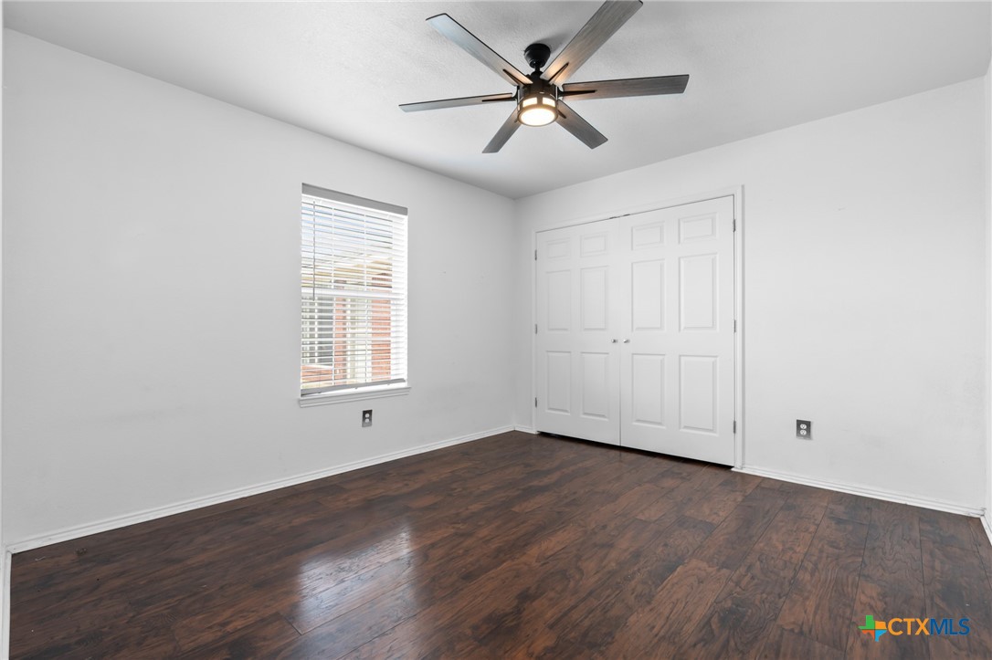 411 Wade Road Eddy, TX 76524 - Photo 34 of 48 a view of an empty room with wooden floor and a window