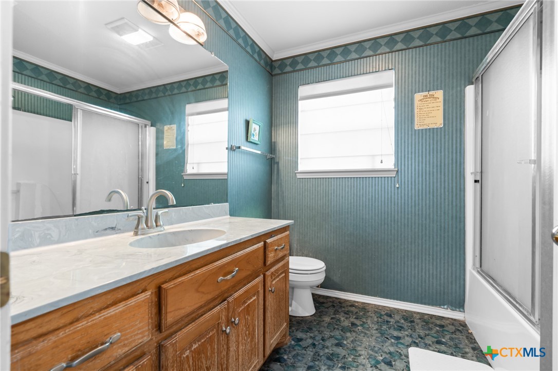 411 Wade Road Eddy, TX 76524 - Photo 35 of 48 a bathroom with a sink a toilet and a mirror
