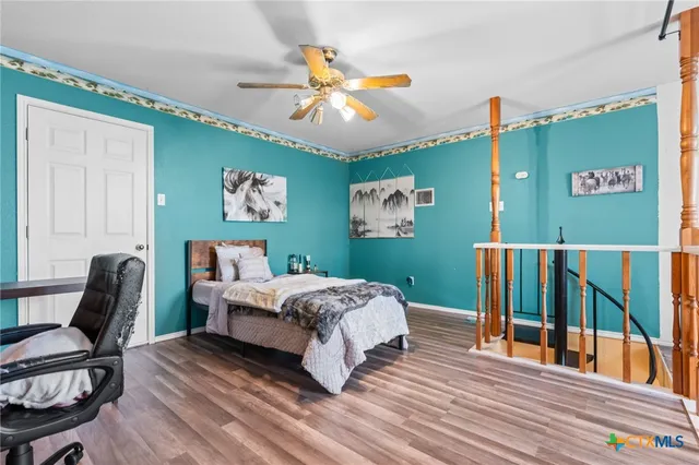 a bed sitting in a bedroom next to a window