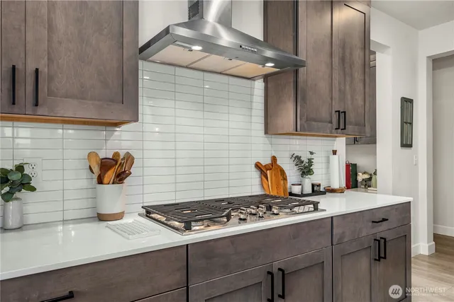 a kitchen with a stove and cabinets