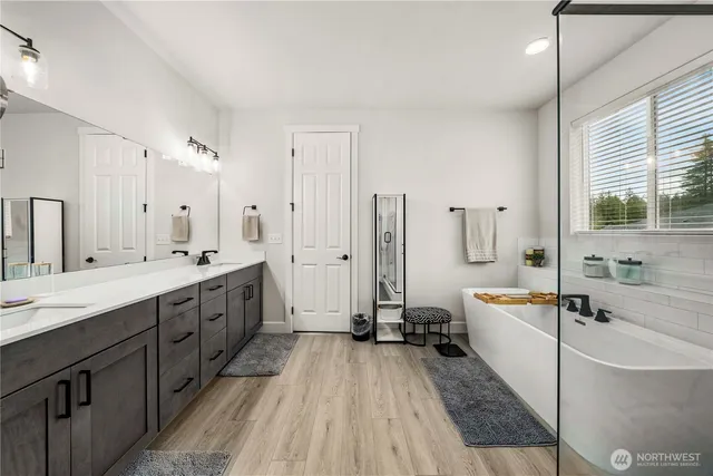 a bathroom with a granite countertop sink double and mirror