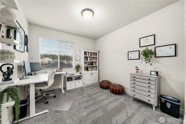a bedroom with a bed a dresser and next to a window