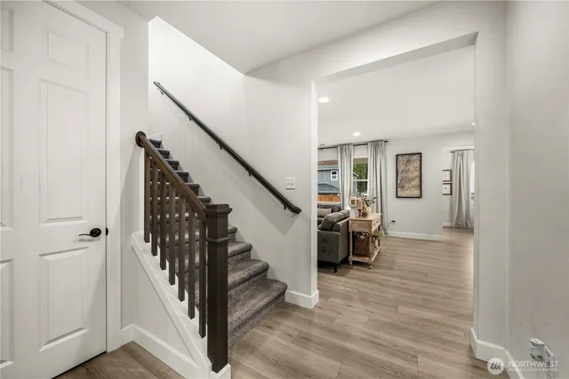 a view of entryway and hall with wooden floor