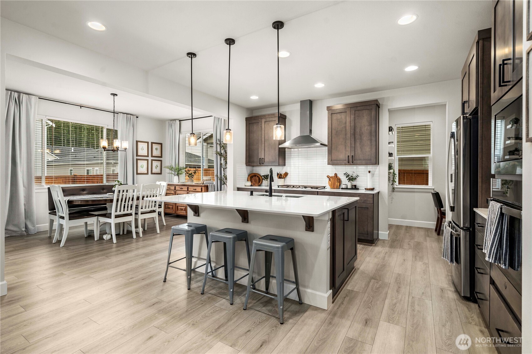 6209 Marymere Rd Port Orchard Southwest Port Orchard, WA 98367 - Photo 10 of 34 a kitchen with stainless steel appliances granite countertop dining table chairs stove a refrigerator and cabinets