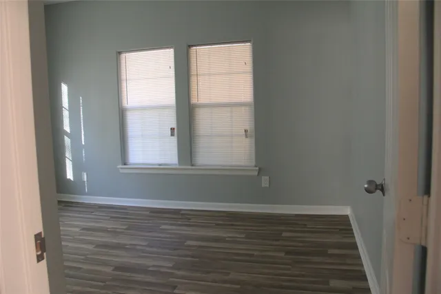a room with wooden floor and window