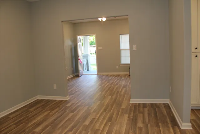 wooden floor in an empty room with a mirror