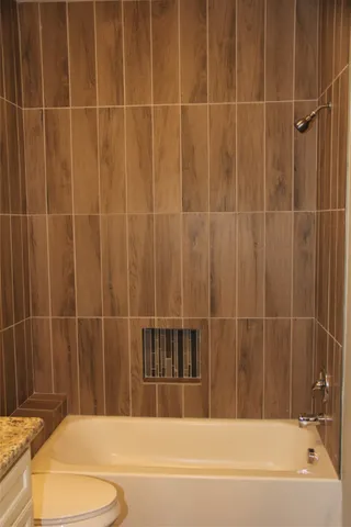 a bathroom with a bathtub and a shower