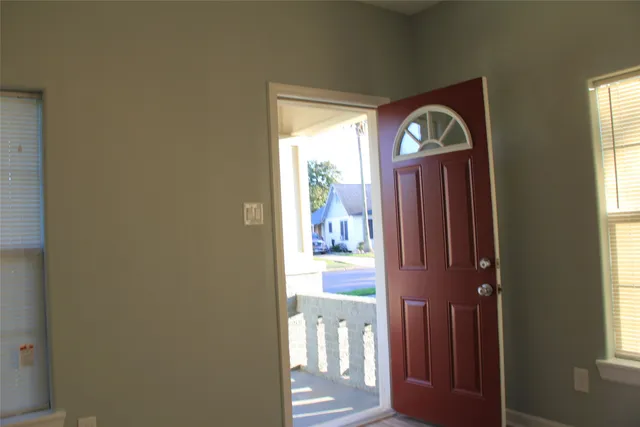 a view of front door with wooden floor