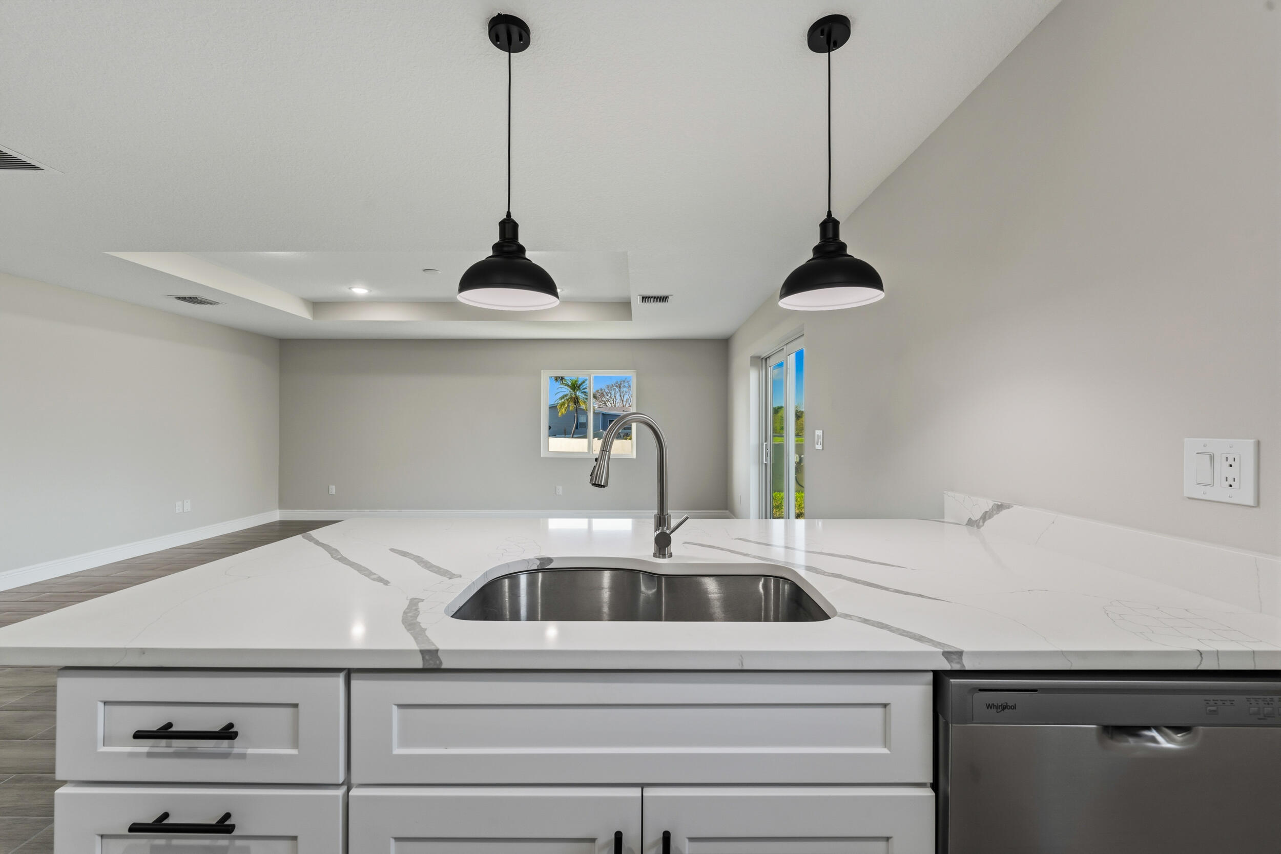 4335 Southwest 15th Way Okeechobee, FL 34974 - Photo 8 of 33 a kitchen with a sink a counter and chandelier