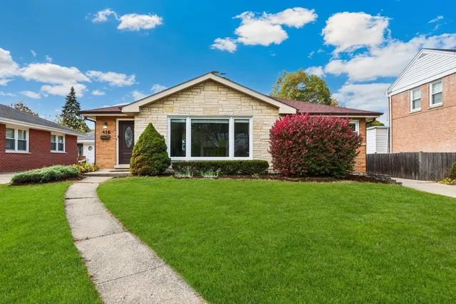 a front view of house with yard and green space