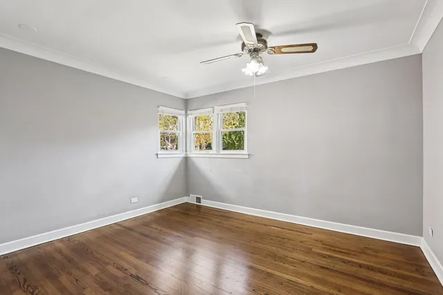 a view of a room with wooden floor closet and windows