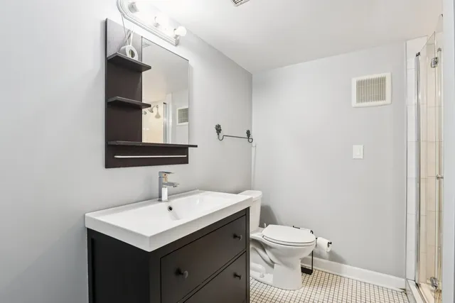 a bathroom with a sink toilet and mirror