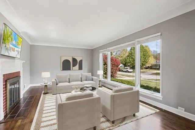 a living room with furniture and a floor to ceiling window