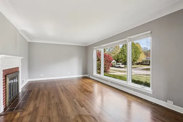 a view of room with window and wooden floor