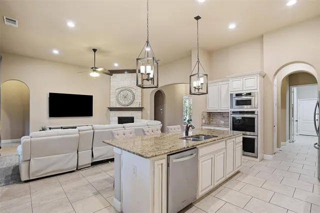 a kitchen with cabinets and chandelier