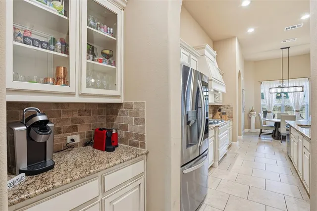a kitchen with stainless steel appliances granite countertop a refrigerator and a sink