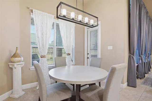 a view of a dining room with furniture and a chandelier