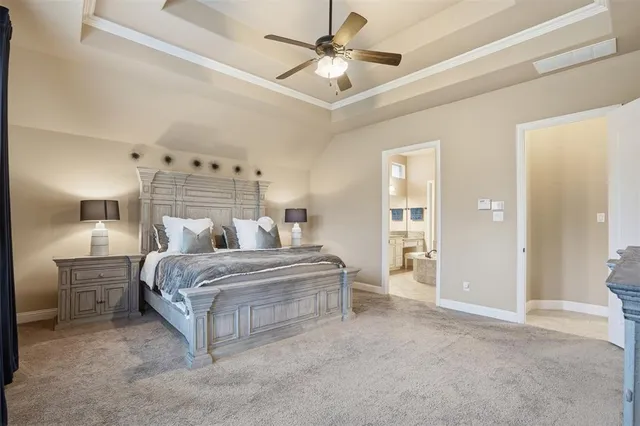 a spacious bedroom with a bed and a chandelier