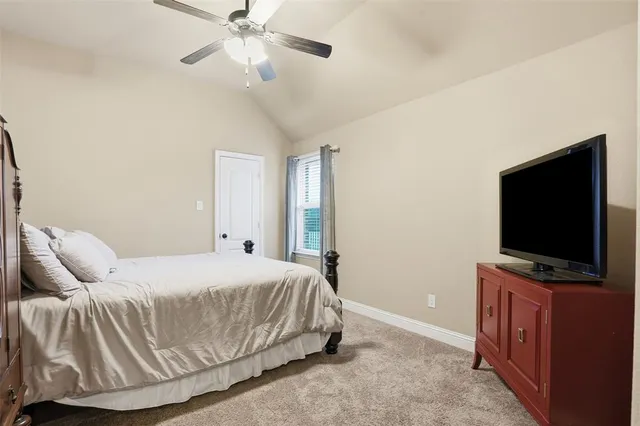 a bedroom with a bed and flat screen tv