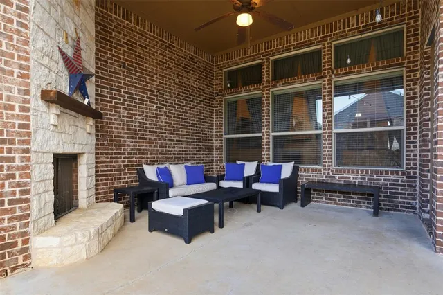 a outdoor space with patio couch and a fireplace